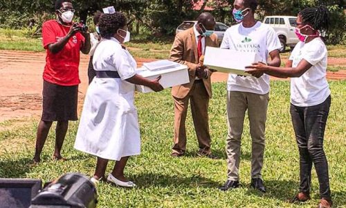 Caroline and another volunteer distribute handmade masks to officials at the Lira Regional Hospital